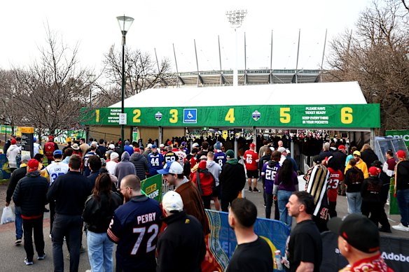 Fans queuing at the temporary entrance to the MCG precinct on Friday.