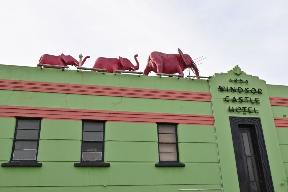 Three pink elephants stride atop the colourful Windsor Castle Hotel.
