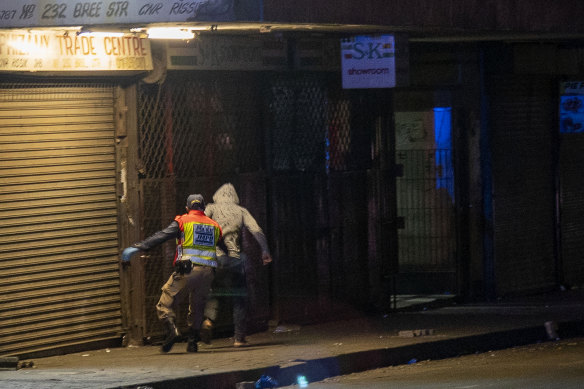 A police officer chases a man who violated the lockdown in Johannesburg, South Africa.