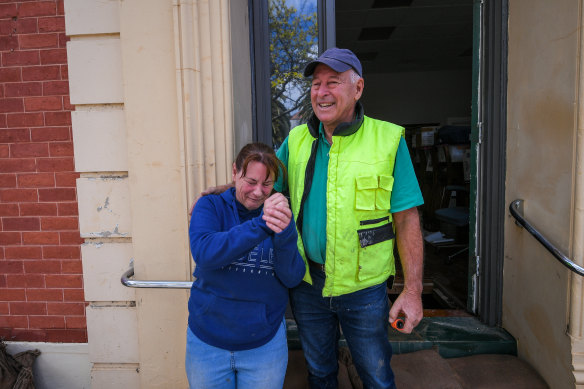 Leanne Hansen’s home was spared, but the damage to the town was overwhelming. Her father John Nicholson offers support.