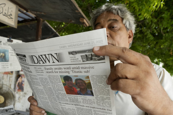 A man in Pakistan reads a copy of a morning newspaper reporting the missing Titanic submersible.