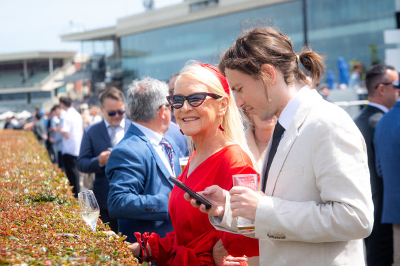 Racegoers enjoy some sunshine at Caulfield racecourse