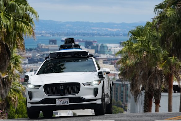 A Waymo taxi drives in San Francisco. Australia’s left-hand driving would require comprehensive retraining of Waymo’s AI for traffic rules, driving behaviours and patterns.