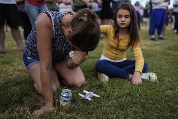 Brandy Rickaba and her daughter Emilie pray during a candlelight vigil for the victims of the shooting.