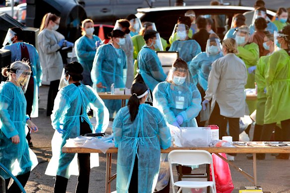 Medical personnel prepare to test hundreds of people lined up in Phoenix in the US on the weekend.