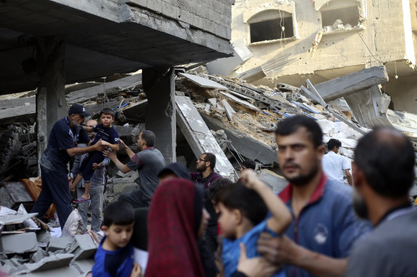 Palestinians evacuate families from their homes after an Israeli airstrike in Jabalia refugee camp on Sunday.