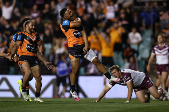 Latu Fainu celebrates a try against Manly.
