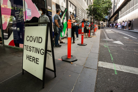 People queuing outside a COVID testing site on Bourke Street in Melbourne.