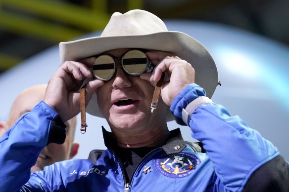 Jeff Bezos, founder of Amazon and space tourism company Blue Origin, puts goggles over his eyes that belonged to aviator Amelia Mary Earhart during a post launch news briefing from its spaceport near Van Horn, Texas.