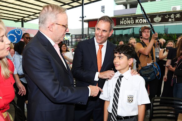 Treasurer Jim Chalmers introduces a boy to Albanese on the campaign trail in Sunnybank, Brisbane, as the prime minister makes a rare public walk.