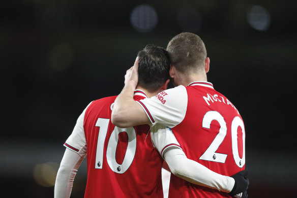 Mesut Ozil (left) celebrates afterscoring Arsenal's third goal.