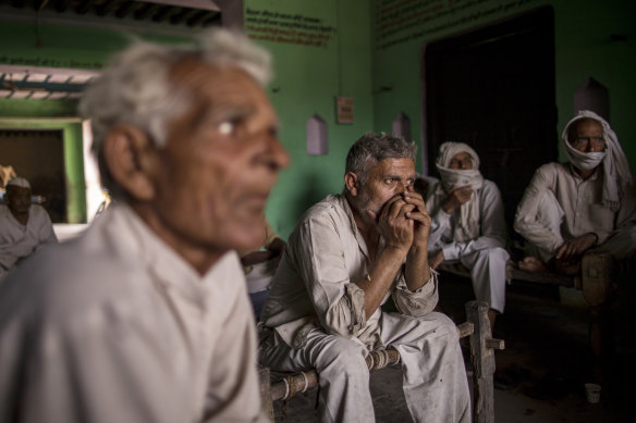 People discuss how to handle the pandemic in the village of Basi, Uttar Pradesh, India.