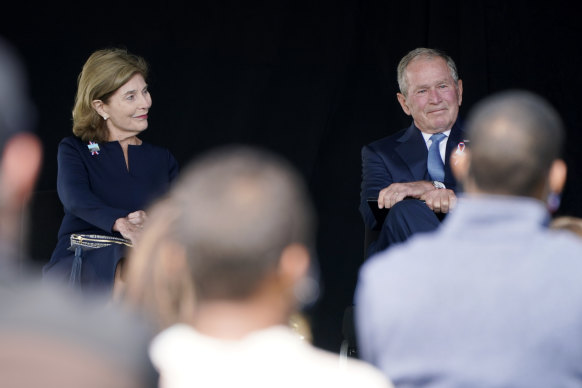 Former President George W. Bush, right, next to former first lady Laura Bush, takes his seat after he spoke at a memorial for the passengers and crew of United Flight 93 at Shanksville, Pennsylvania.