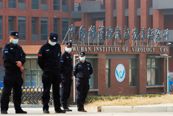 Security personnel keep watch outside Wuhan Institute of Virology during the 2021 visit by the World Health Organization (WHO) team tasked with investigating the origins of the coronavirus disease (COVID-19).