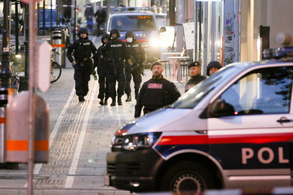 Police patrol at the scene early on Tuesday following an attack on people enjoying a last evening out before lockdown in Vienna.