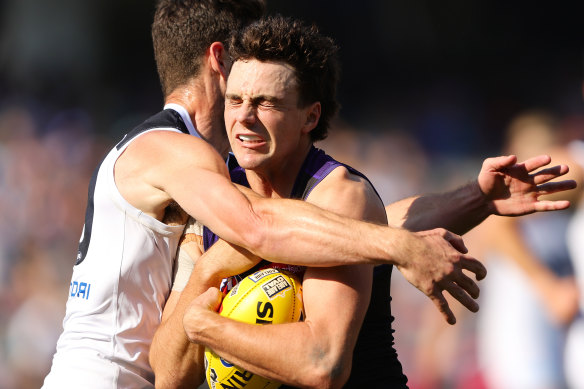 Jordan Clark is tackled by Carlton’s George Hewett during the Dockers’ loss to the Blues on Saturday.