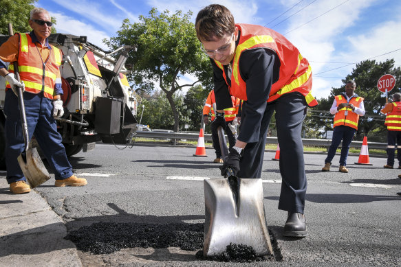 Minister Jaala Pulford helps out with road repairs last year.
