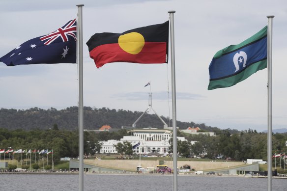 The Australian flag,  the Aboriginal flag and the Torres Strait Islander flag flying in Canberra.