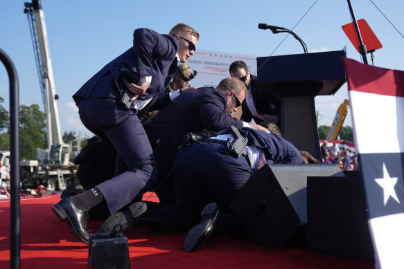 Republican presidential candidate former President Donald Trump is covered by US Secret Service agents at a campaign rally in Pennyslvania.