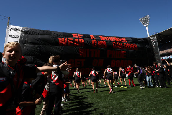 The Bombers walk out before the match.
