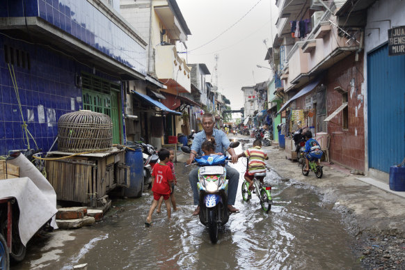 A flooded street in the Muara Baru district of Jakarta back in 2015.