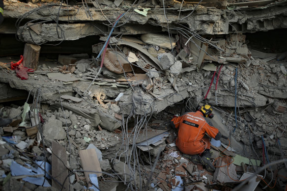 A Turkish rescue worker checks a collapsed building in Adiyaman, southern Turkey on Saturday.