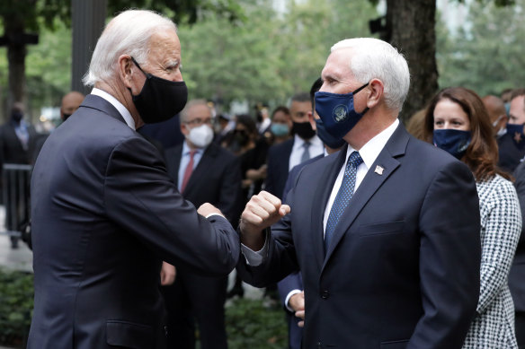 Joe Biden and Mike Pence bump elbows at the 9/11 memorial in New York.