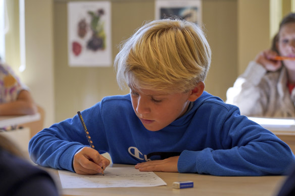 A child practices handwriting at the Djurgardsskolan elementary school in Stockholm, Sweden.