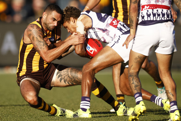 Hawthorn’s Shaun Burgoyne attempts to bring down Fremantle’s Liam Henry.