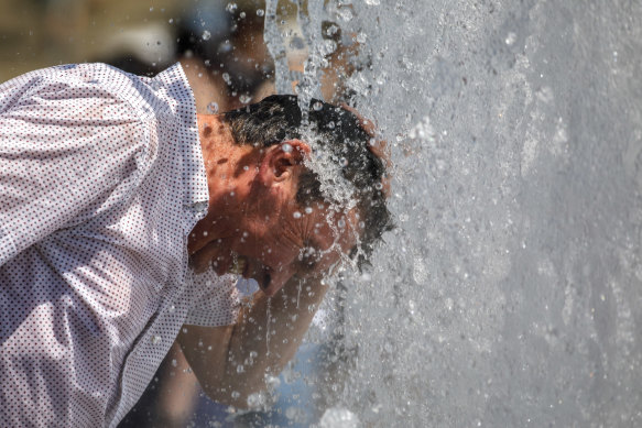 A man tries to cool off at a fountain in Berlin, Germany on a day where the temperature reached 37 degrees celsius this month.