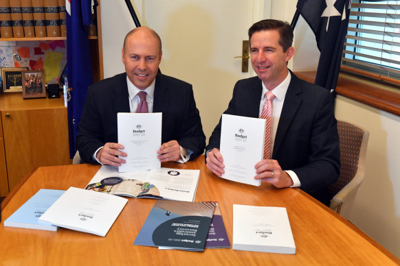 Treasurer Josh Frydenberg and Finance Minister Simon Birmingham with the 2021 budget papers at Parliament House on Tuesday.