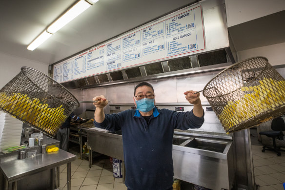 John Tang at Bulleen Fish and Chips prepares for the traditional Good Friday rush despite the coronavirus outbreak.  