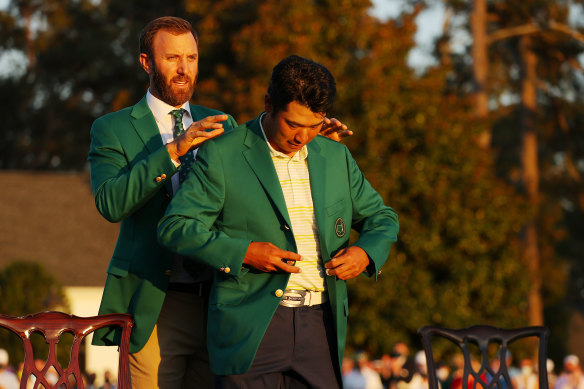 Hideki Matsuyama of Japan is awarded the Green Jacket by 2020 Masters champion Dustin Johnson.