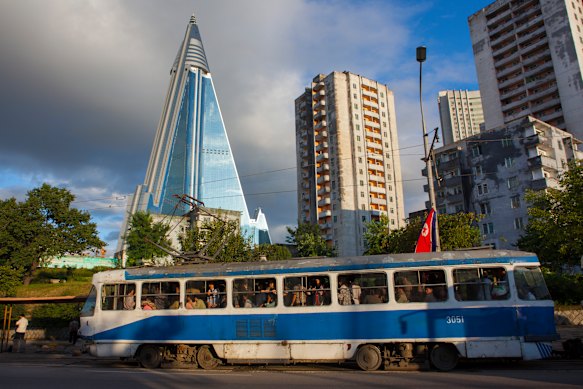 A tram passes in front of the pyramid-shaped Ryugyong Hotel in Pyongyang.