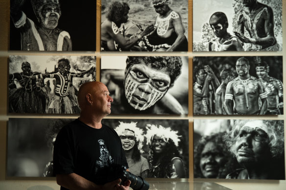Photographer Wayne Quilliam with his work in the exhibition.