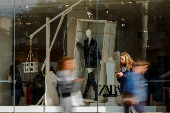 People walk past a Zara shop window in Barcelona, Spain earlier this month.