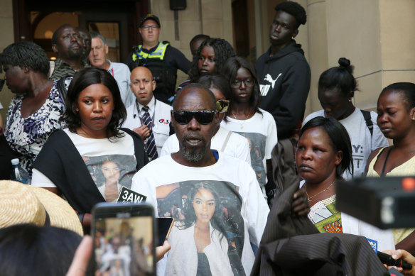 Surrounded by family and friends of Laa Chol, her father, Daniel speaks to the media outside court on Friday.