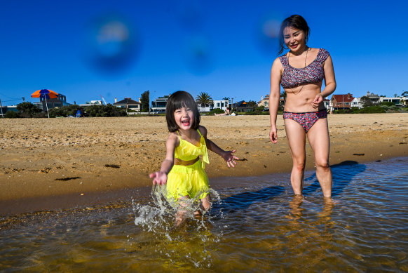 Crystal and daughter Harper enjoy Brighton beach. Above-average temperatures have been forecast for much of the state.