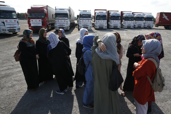 Members of a Turkish pro-government aid group wait in Istanbul for the departure of trucks carrying humanitarian aid destined for Idlib, Syria.