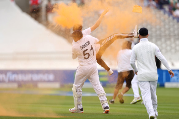 Jonny Bairstow tackles the protestor. 