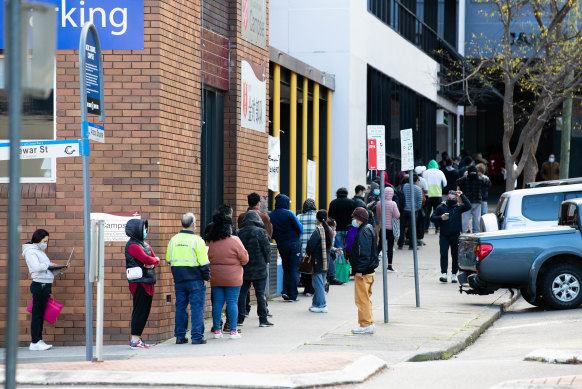 People line up around the block for Centrelink in Campsie, in south-west Sydney, after the lockdown began.