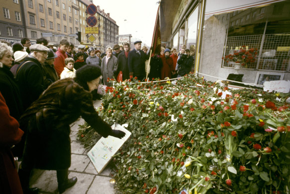 People lay flowers at the site where Olof Palme was shot in 1986.