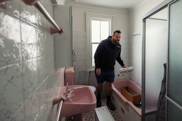 Symes in the existing pink bathroom.