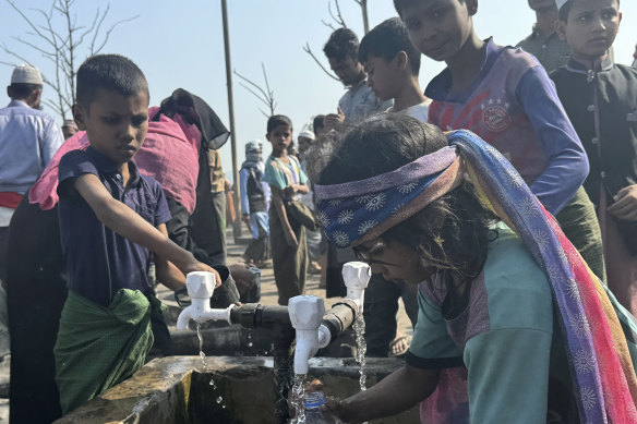 Rohingya refugee children collect drinking water after a midnight fire raced through their refugee camp at Kutupalong in Cox’s Bazar district, Bangladesh, on January 7.