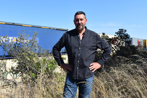 Pete Read and dozens of other residents say a large concrete wall under construction to protect residents at new estate from the  noisy freight line is bouncing the problem over established suburbs.