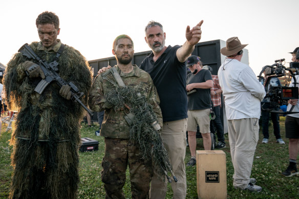 Garland (right) on the set of his film, in which heavily armed factions battle for control of the not-so-united States.