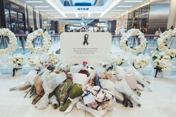 The temporary memorial inside the Westfield Bondi Junction quickly filled up with floral tributes.