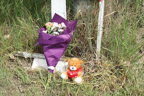 A teddy bear and wreath have been left at the scene of an accident on School Road in Logan Park.