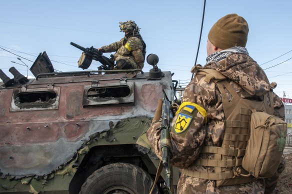 Kharkiv authorities said that Ukrainian forces, yellow armband, engaged in fighting with Russian troops that entered the country’s second-largest city on Sunday.