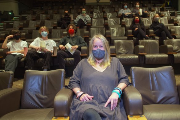 Sun Theatre staff, including Krissa Jansson (front), give socially distant seating a trial run.